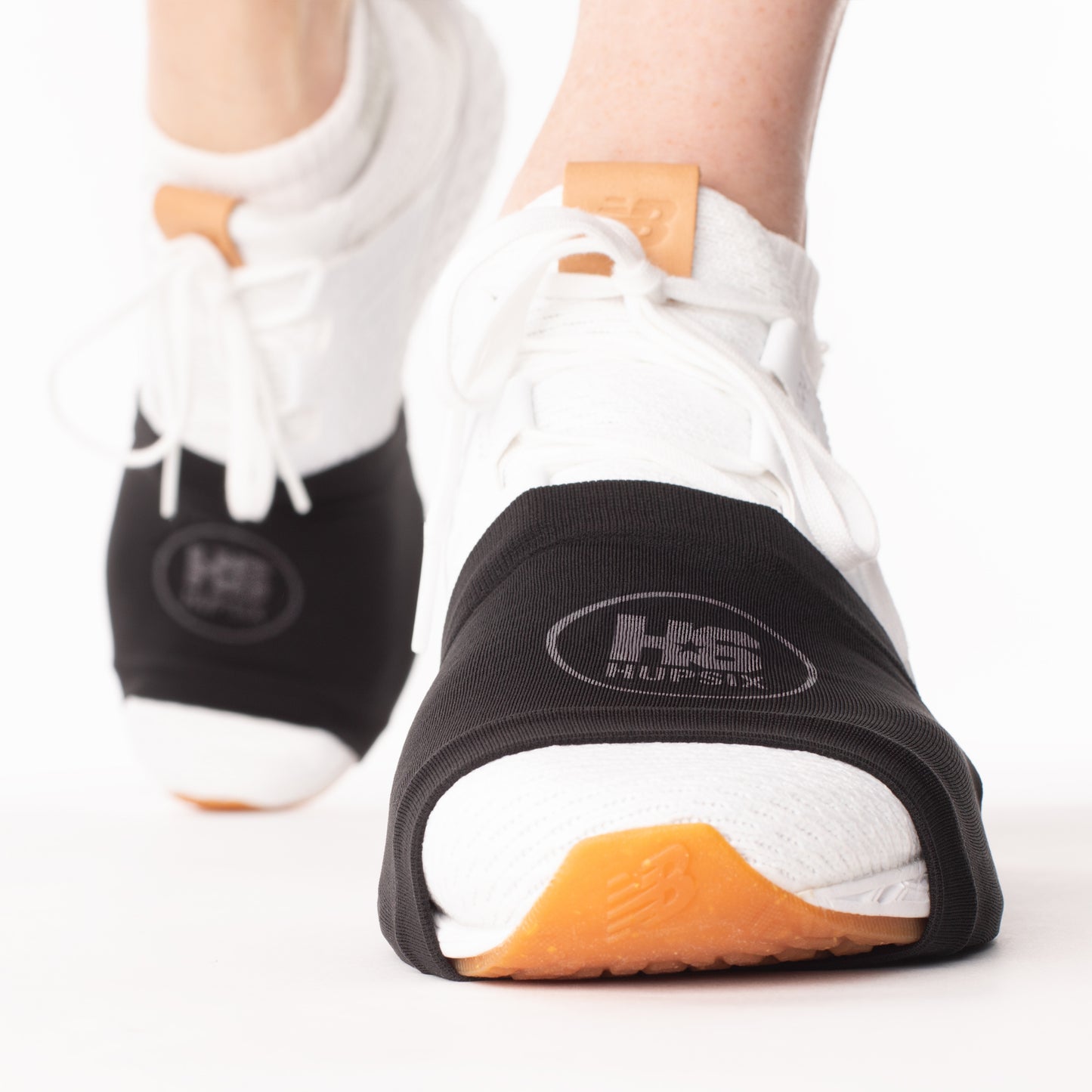 The HupSix over sneaker socks. They protect your knees and ankles twisting and turning on smooth floors. They are one size fits all for men and women and are required for all HupSix classes.