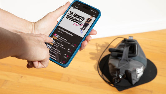 HupSix gear with person holding the app, showing Garmin heart rate zones and cardio tracking.