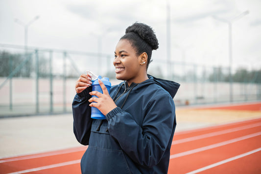 Smiling woman mid-workout on HupSix gear, radiating the feel-good energy of runner’s high.